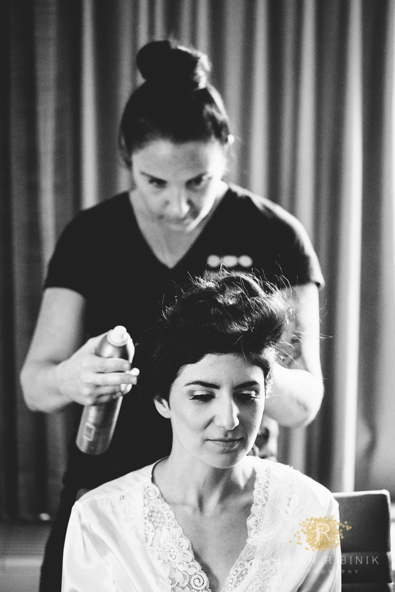 Hairstylist does the bride's hair
