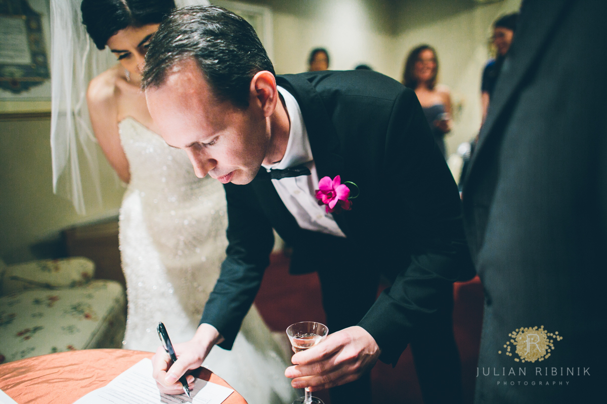 The groom signs the wedding contract