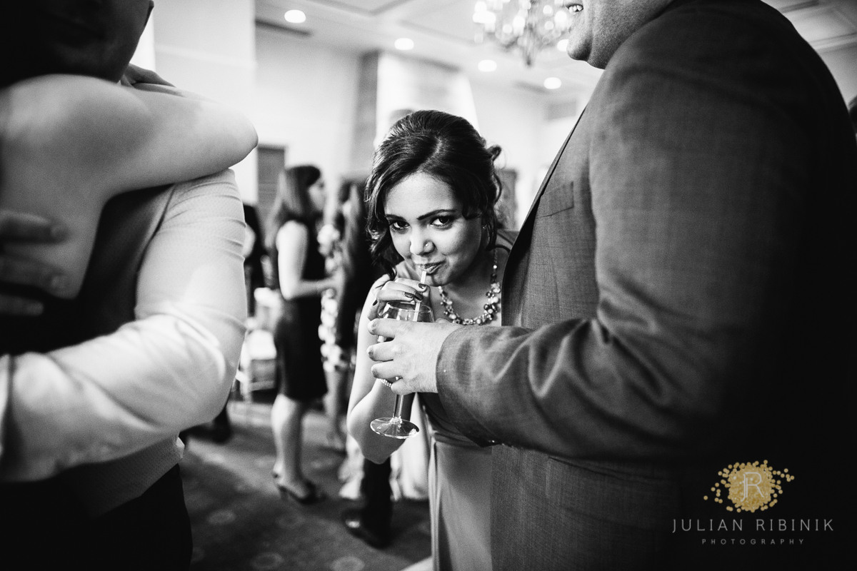 A guest sipping a drink at the wedding reception 
