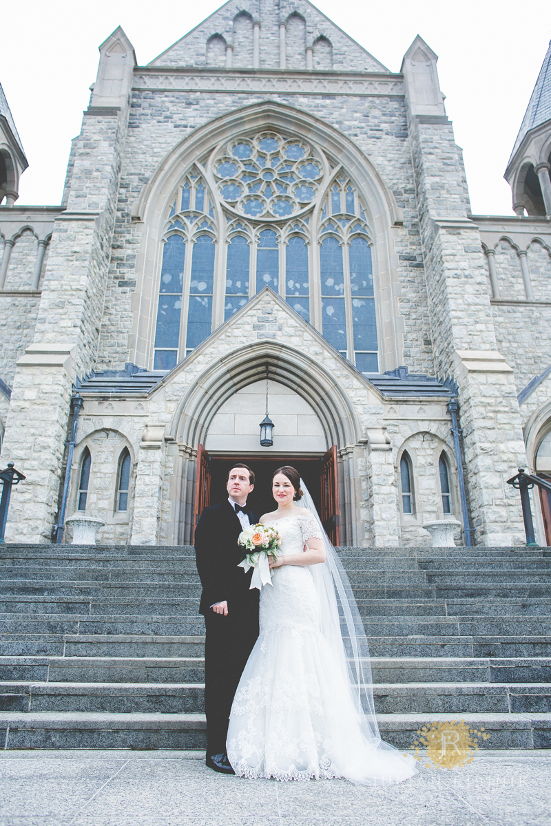 Bride and groom posing for a photo outside the church after wedding in New Jersey