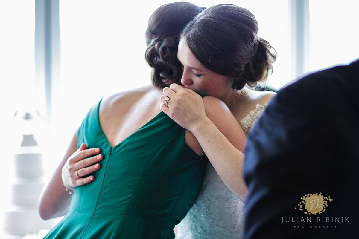 The bride hugs her bridesmaid