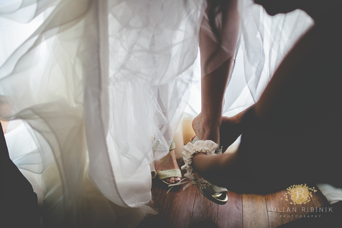 The bride putting on her bridal sandals