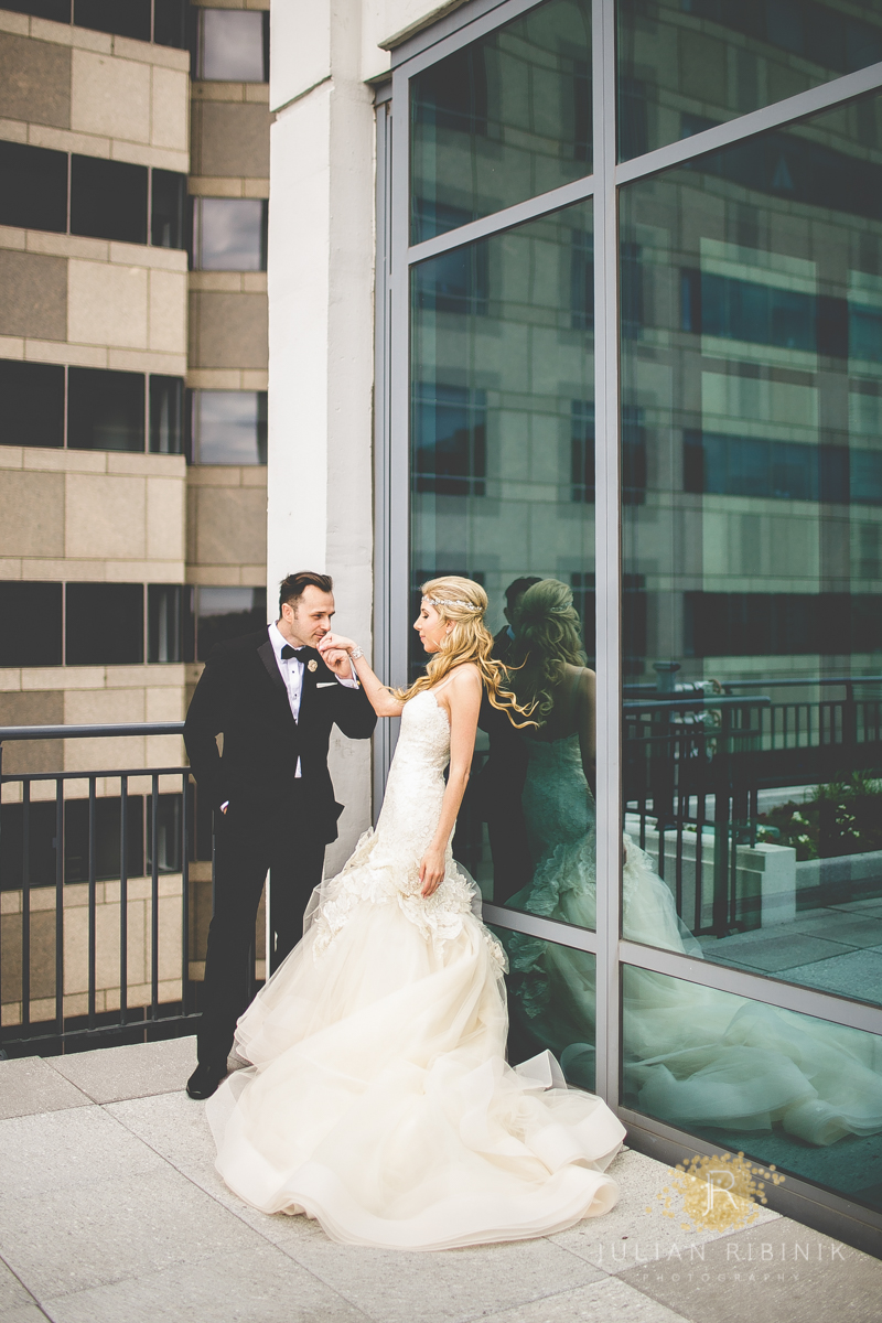 Bride and groom have a personal moment on terrace top of a hotel in Philadelphia