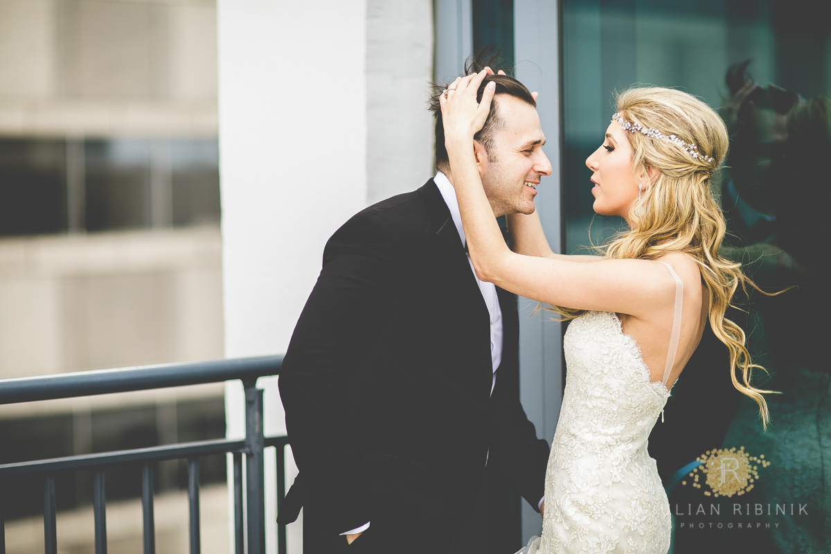 Bride touches the grooms forehead as he smiles