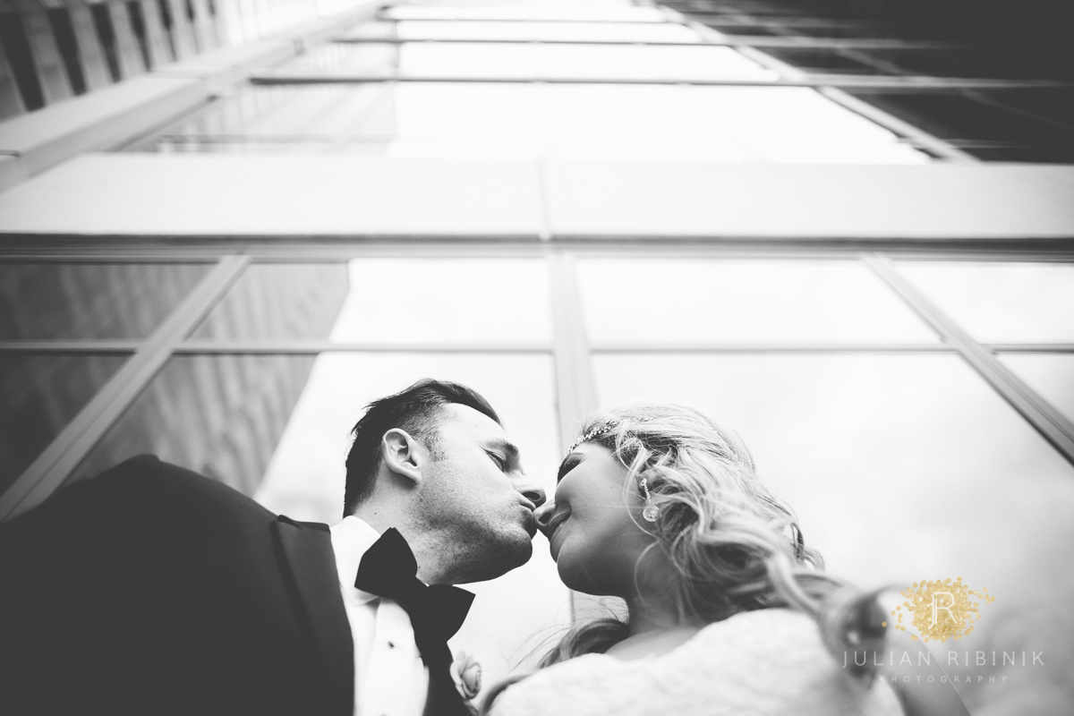 Groom kisses the bride on nose as she blushes