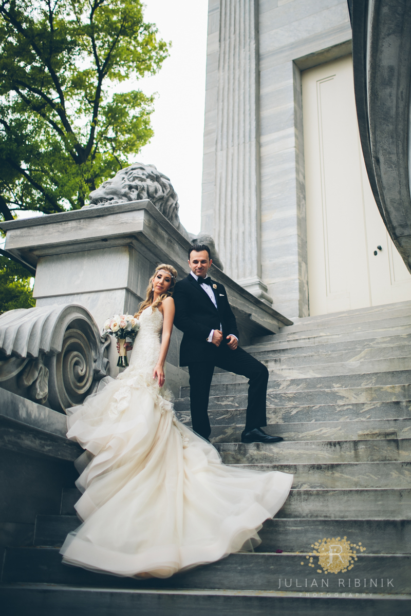 Bride and groom pose for a photo on stairs