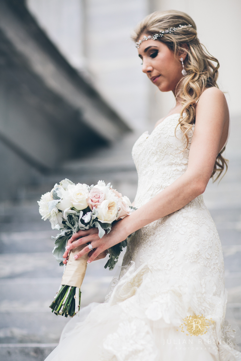 The bride looks at her lovely wedding bouquet
