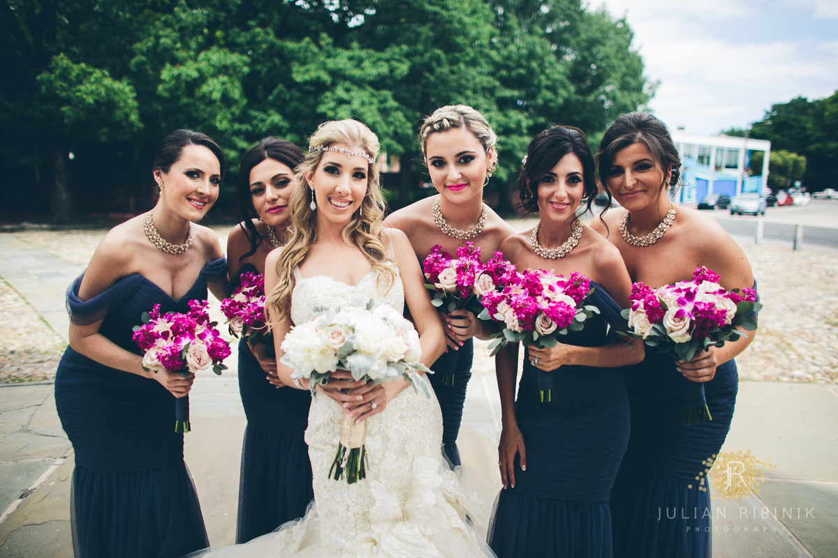 The bride and bridesmaids pose for a photo
