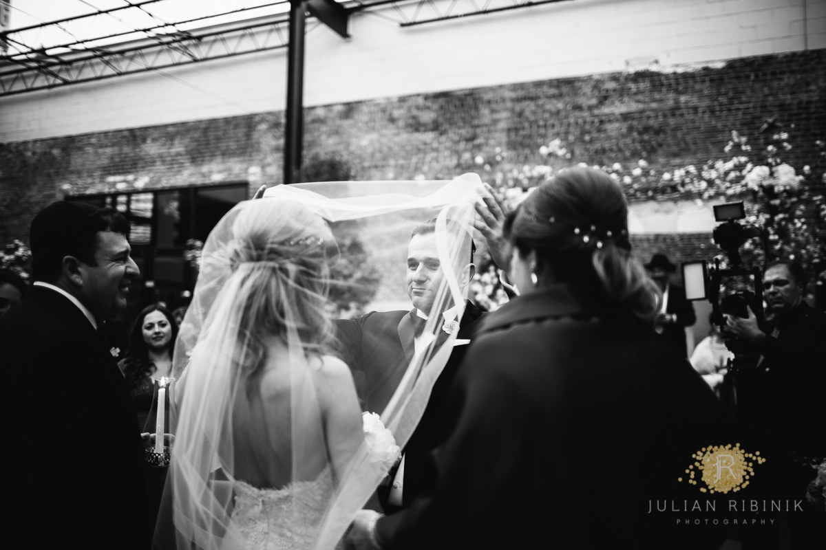 Groom lifts veil of bride before the wedding ceremony