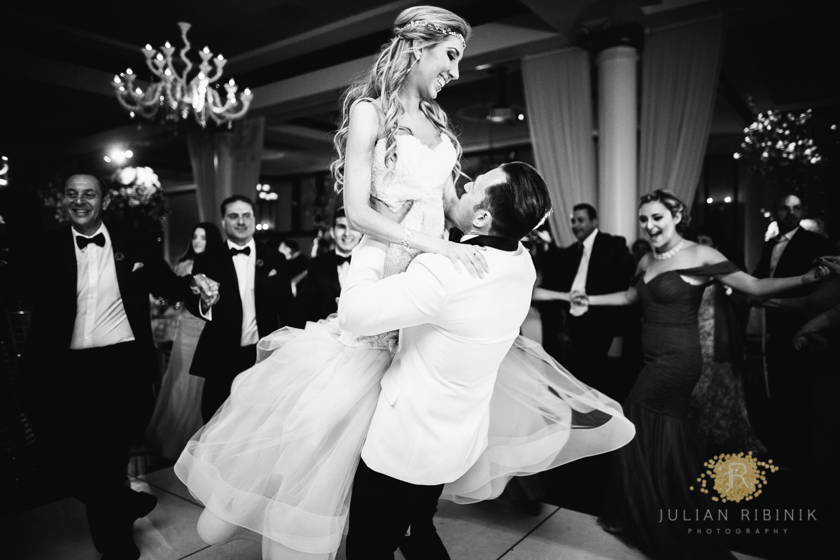 Black and white photo of bride and groom dancing at the reception