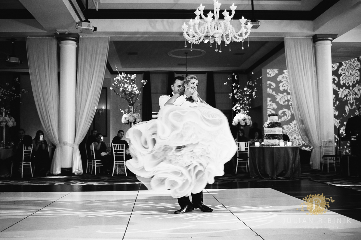 Black and white photo of bride and groom dancing
