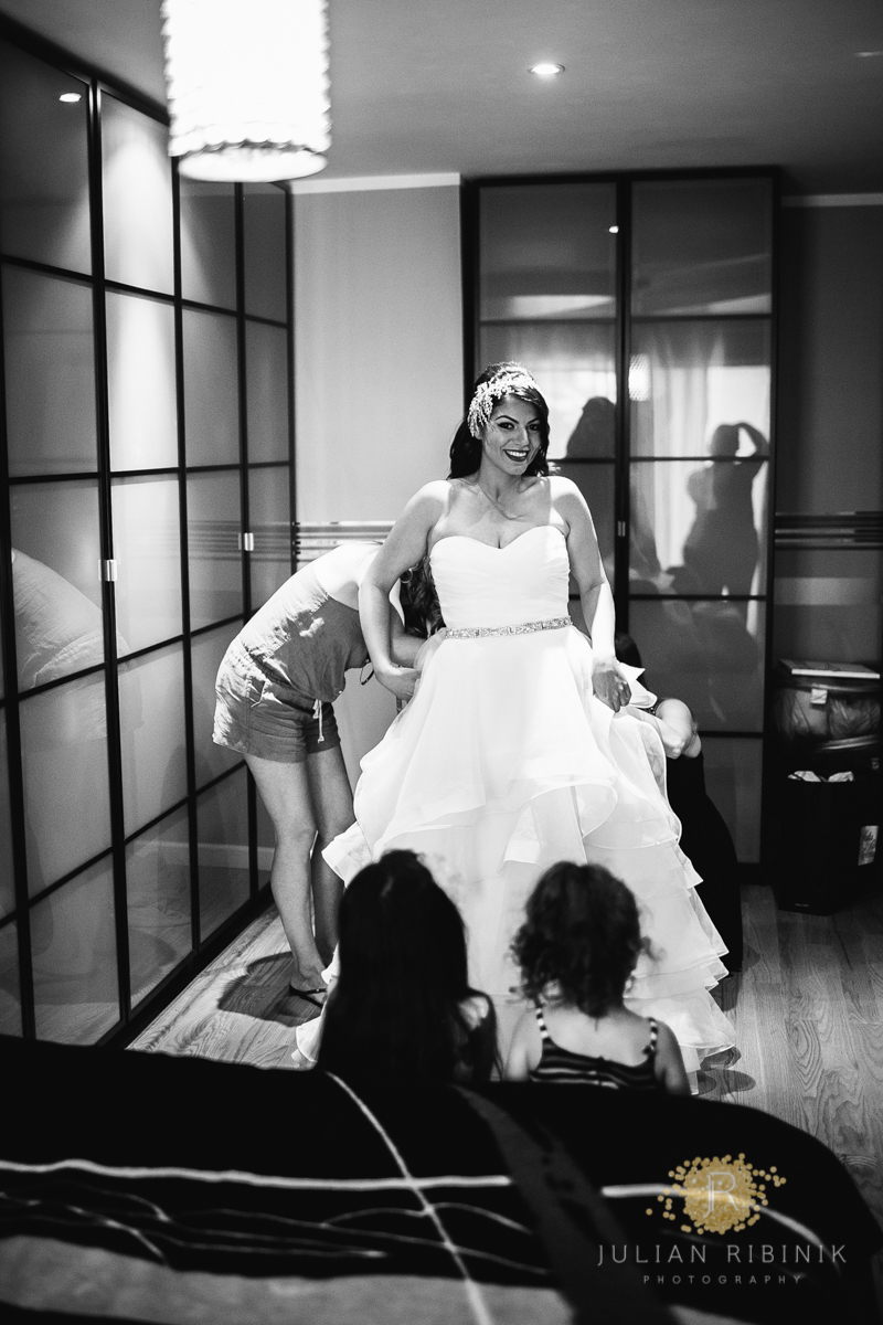 A black and white photo of the bride getting ready