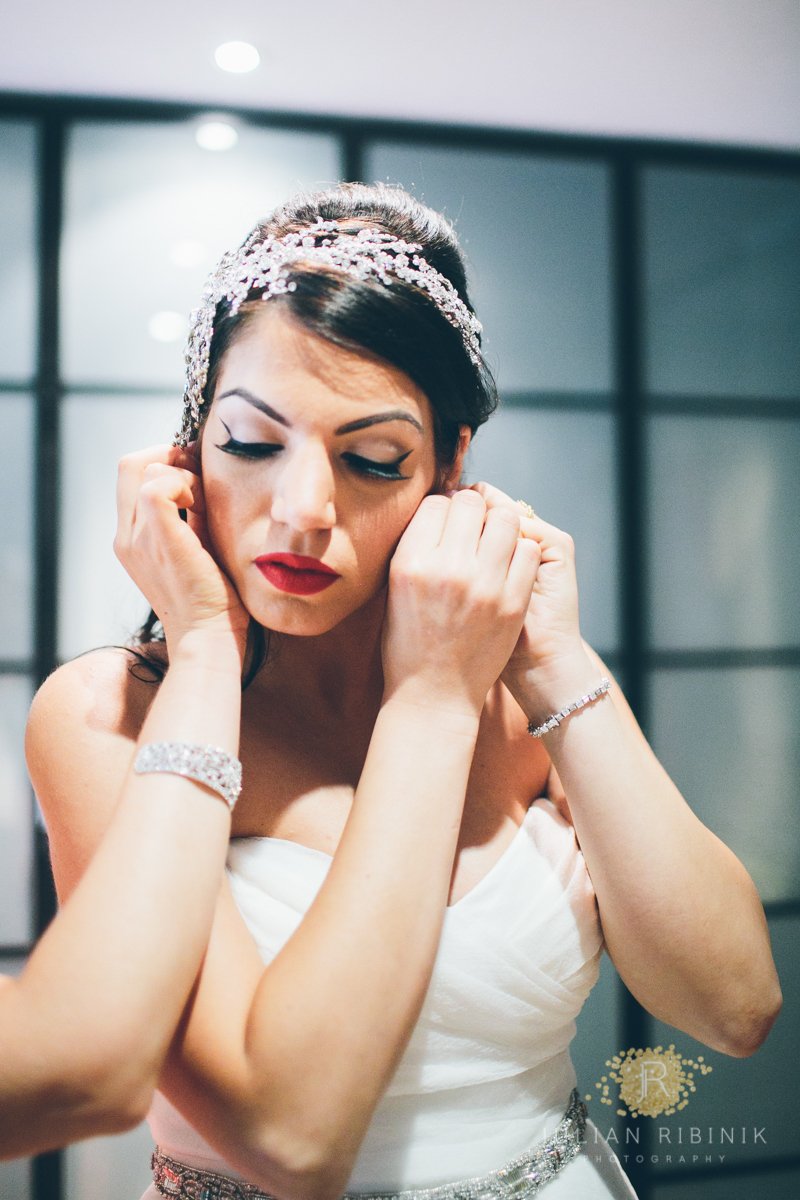 Bride wearing her earrings 