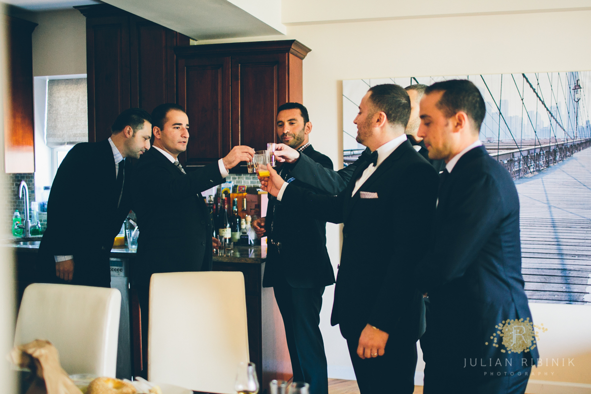 The groom raises a toast with friends before the wedding