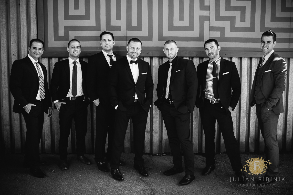 A black and white photo of groomsmen with the handsome groom