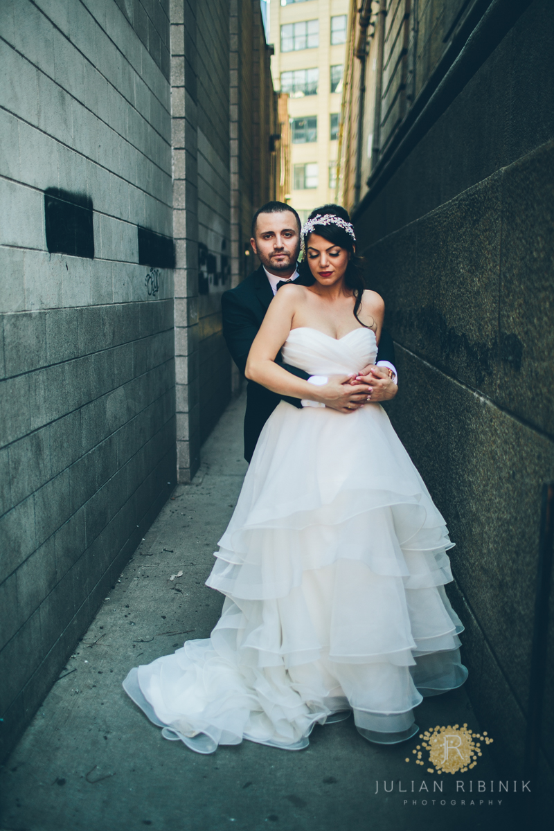 Bride and groom holding each other in a NY lane