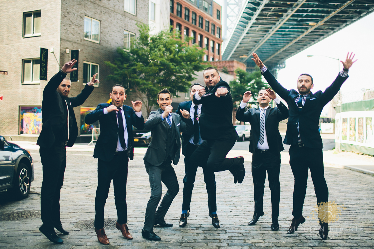 Groomsmen and groom have a light moment