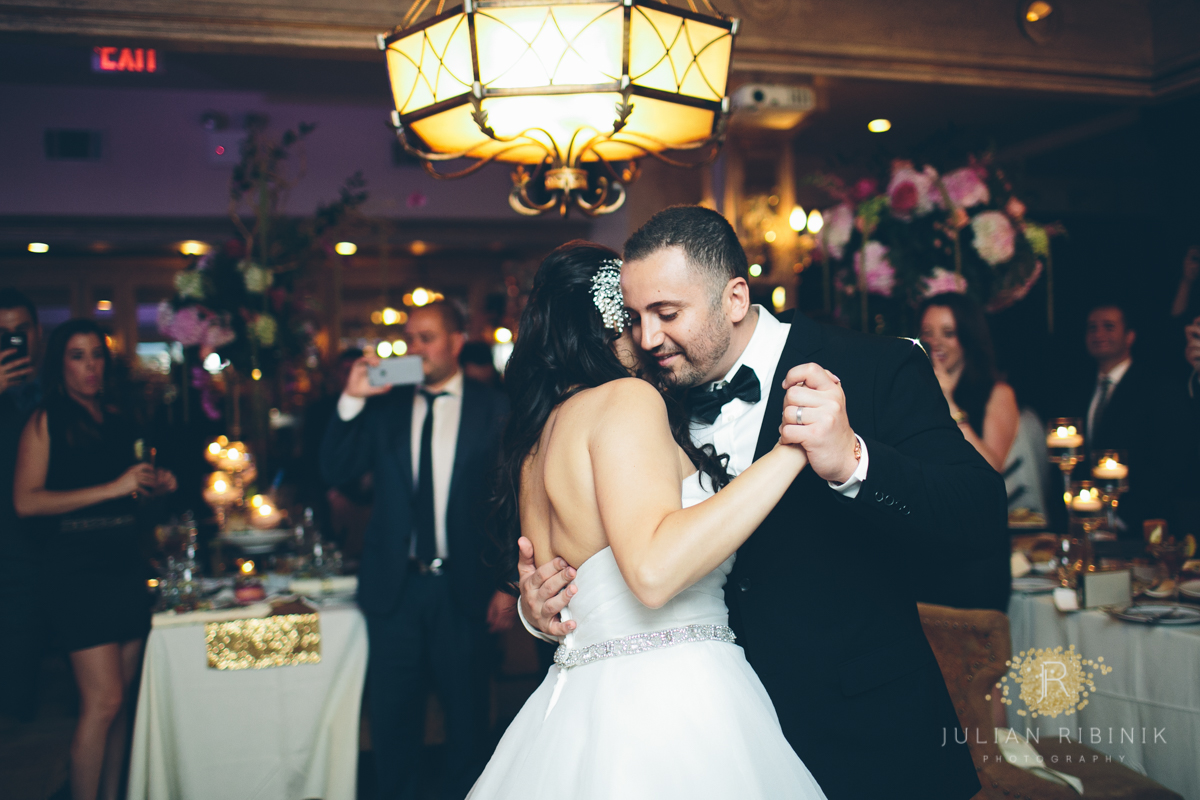 Bride whispers in grooms ear as they dance along