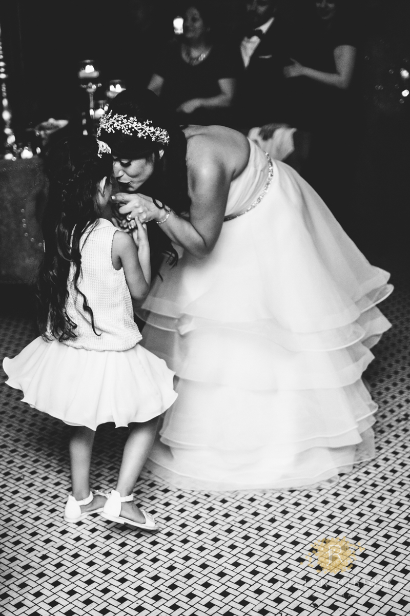 Bride kissing the flower girl