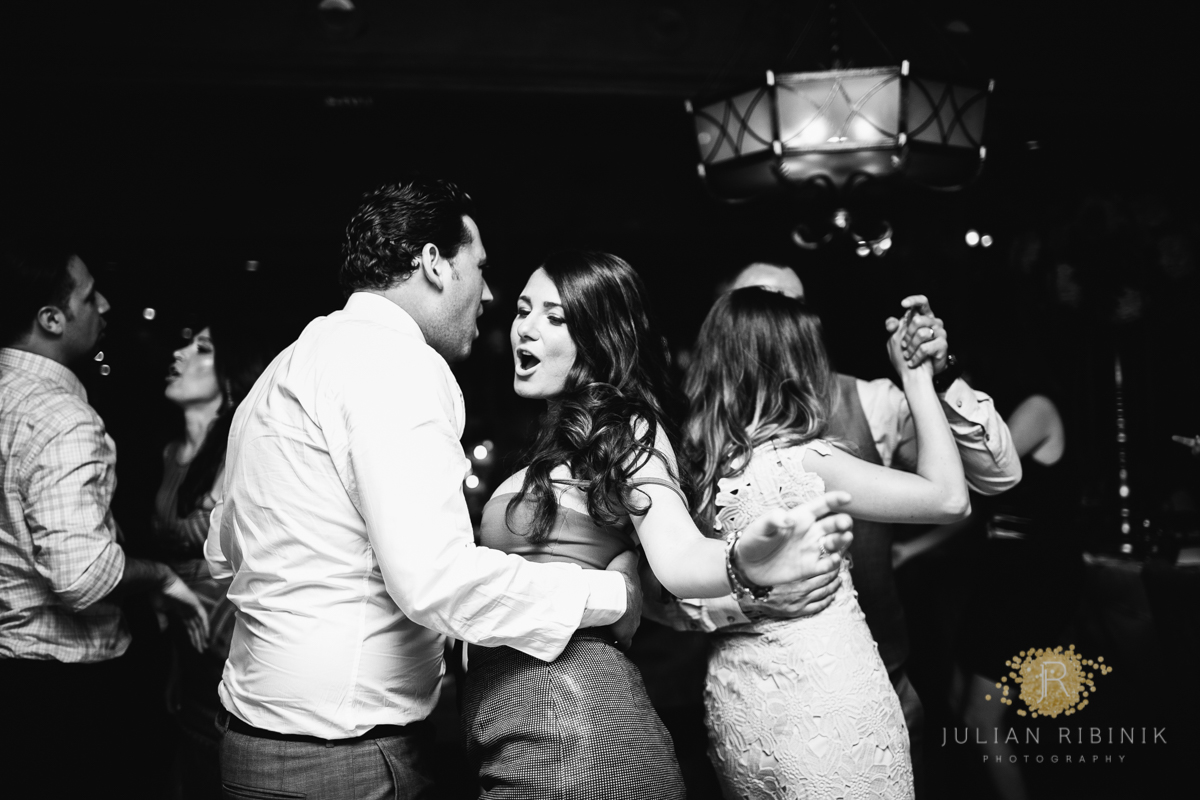 A black and white shot of couple dancing at the reception