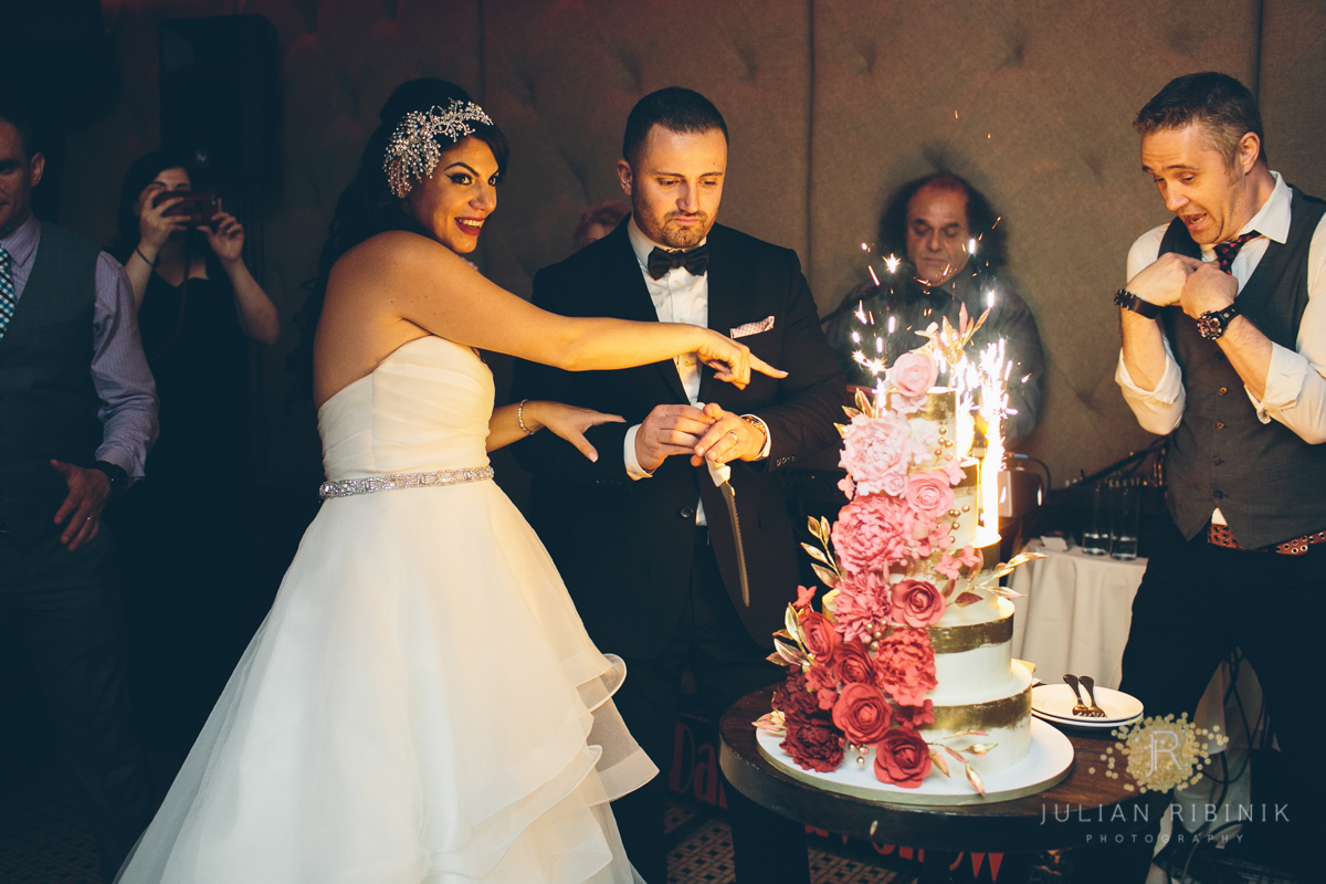 Bride and groom react to the sparkles on the wedding cake