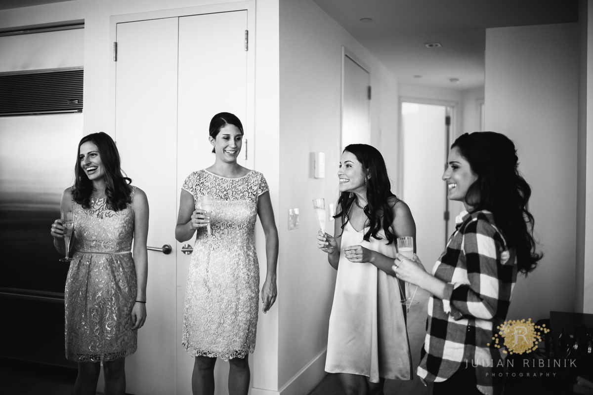 A black and white photo of bride having a toast with friends