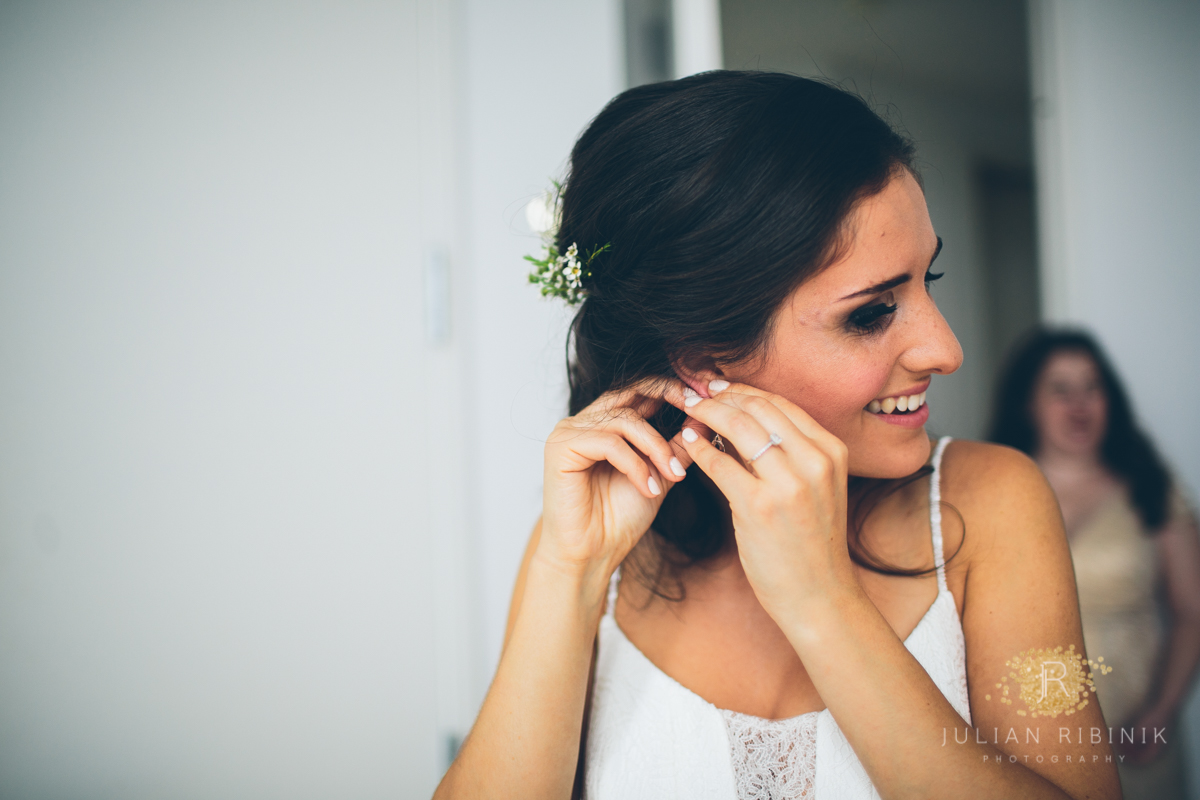 Bride wearing her earrings