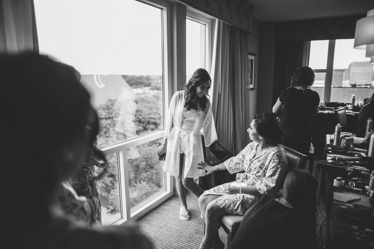 A black and white photo of a bride getting ready for her big day