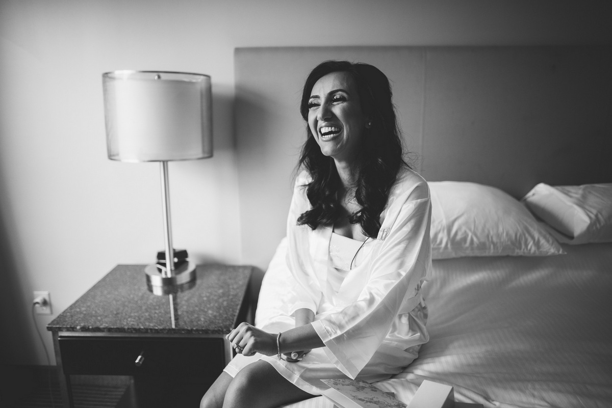 A black and white photo of a happy bride