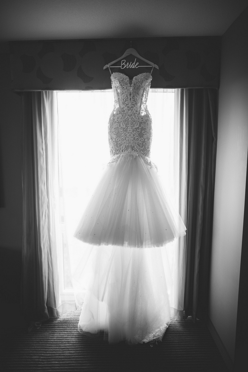 A black and white image of a fancy wedding gown