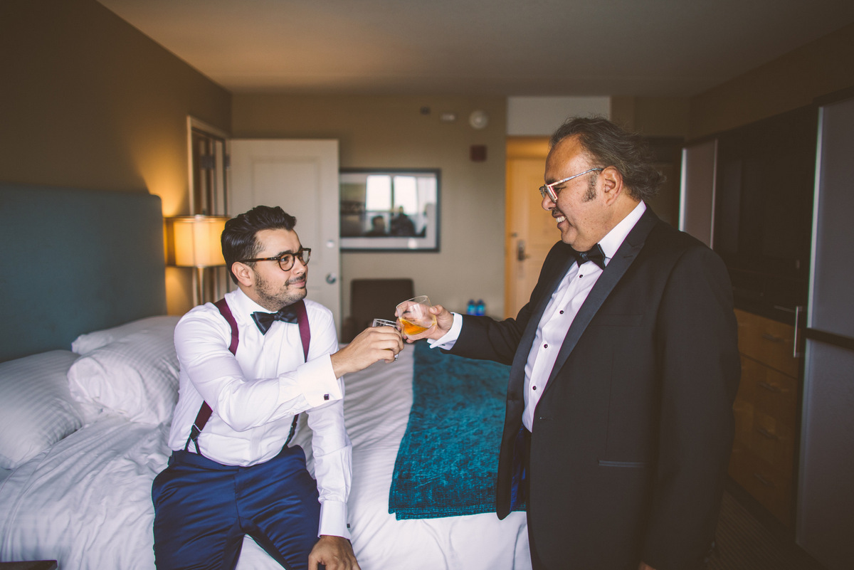 The groom making a toast with his father before the wedding