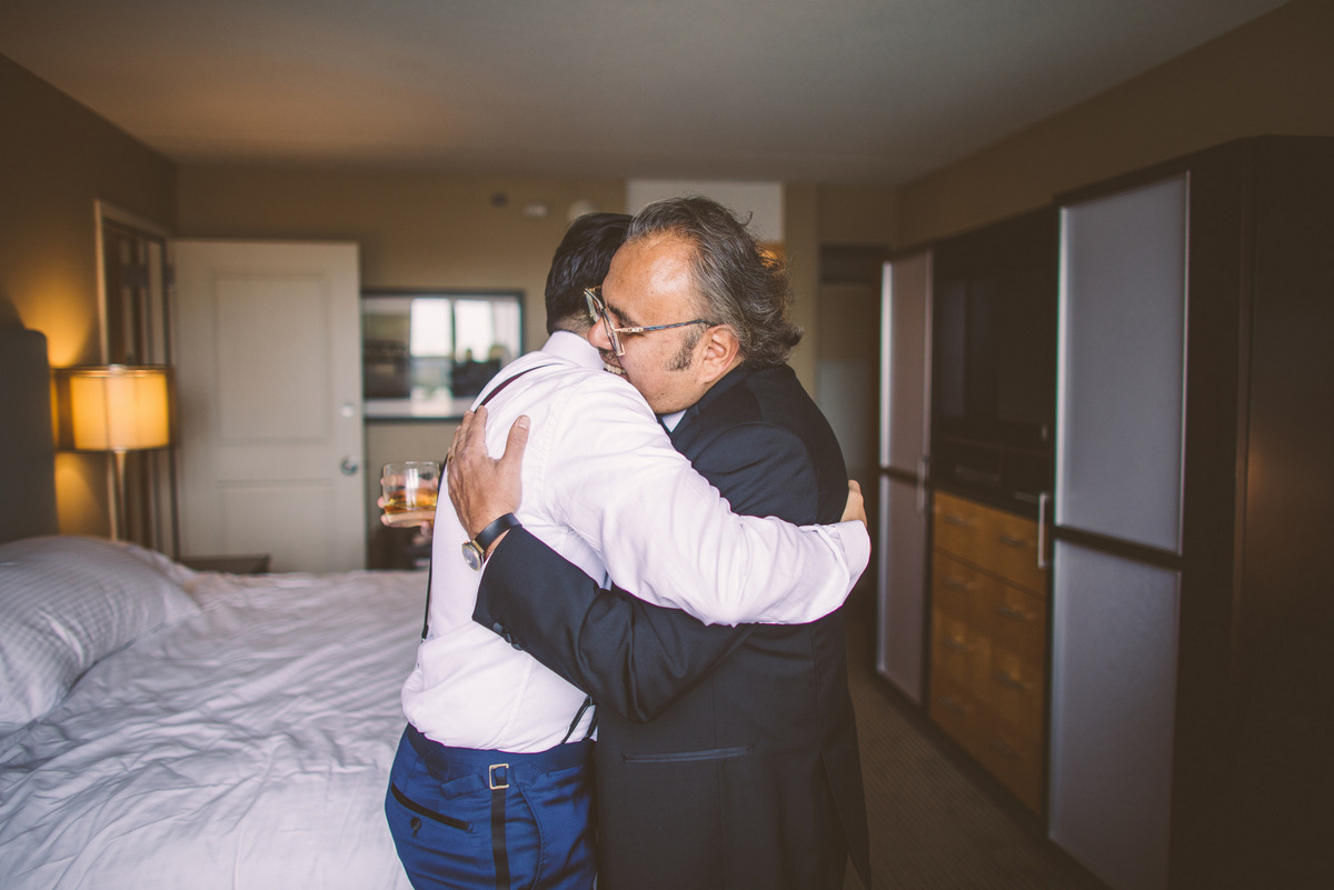 The groom embracing his father before the wedding
