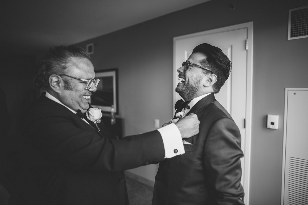 The groom laughing with his father