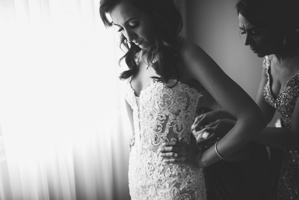 A black and white shot of the bride and her mother getting ready