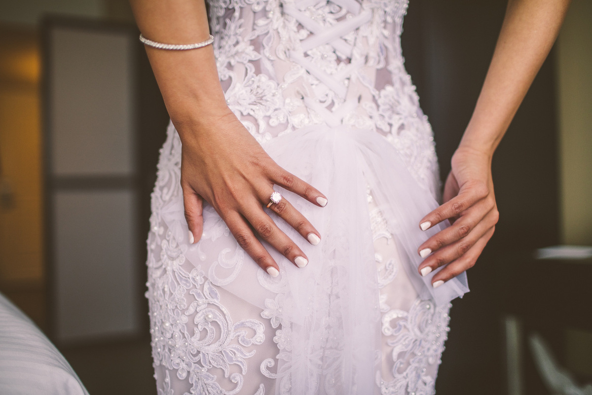 Showing off an elegant dress and wedding ring