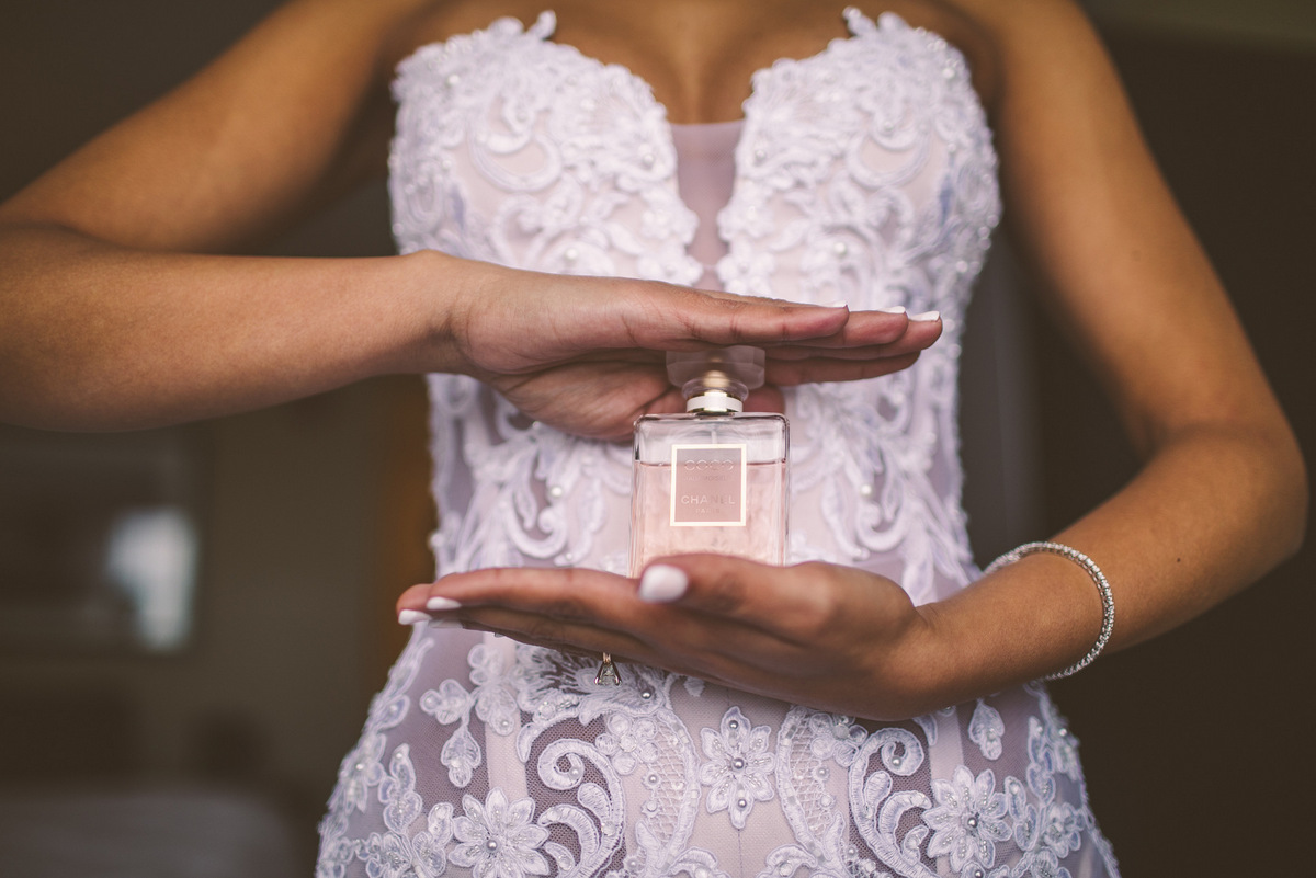 A bride posing with Chanel perfume