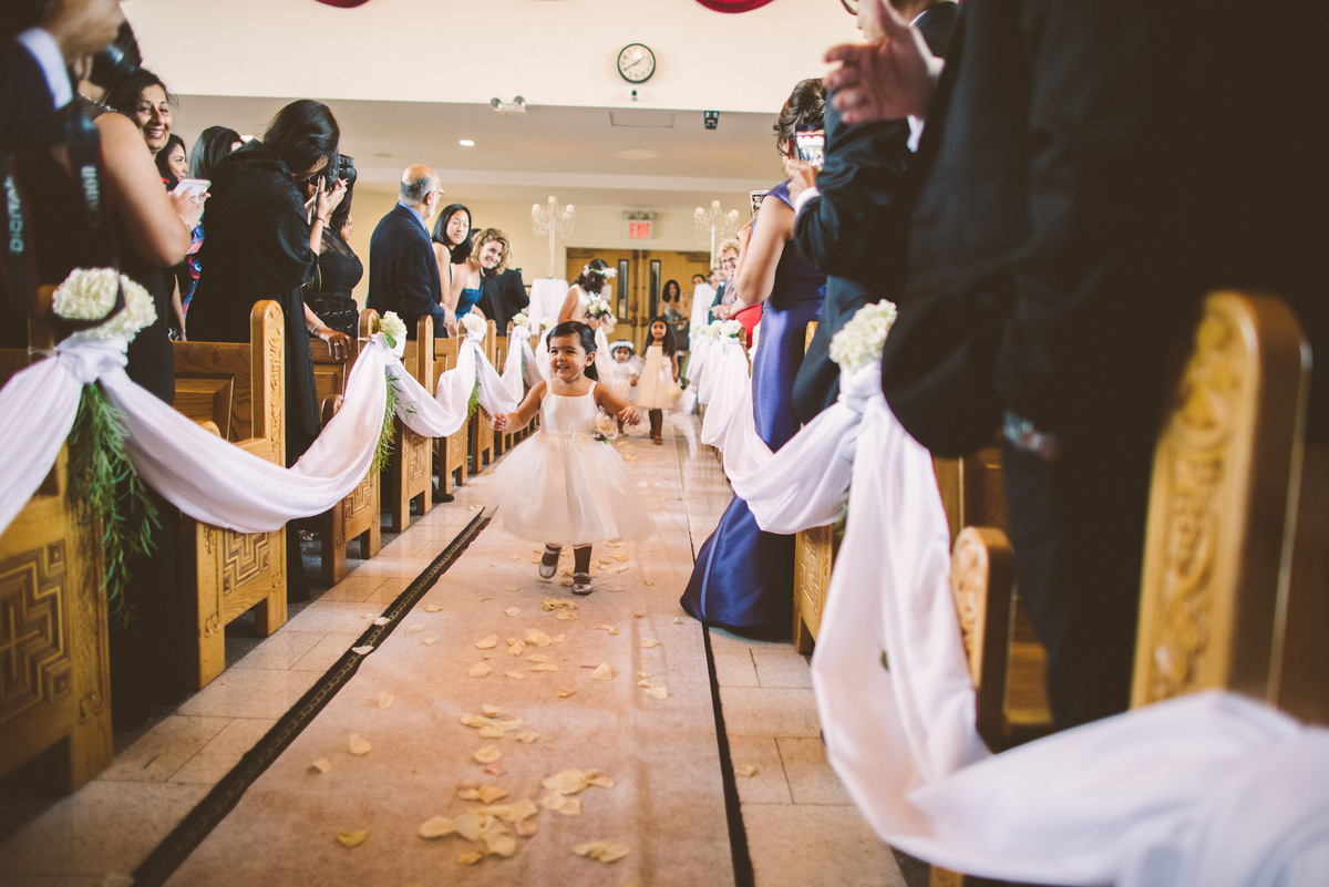 The adorable flower girl coming down the aisle