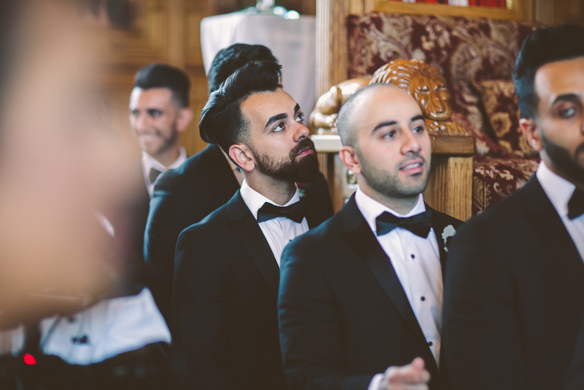 The groomsmen look on as the wedding ceremony takes place