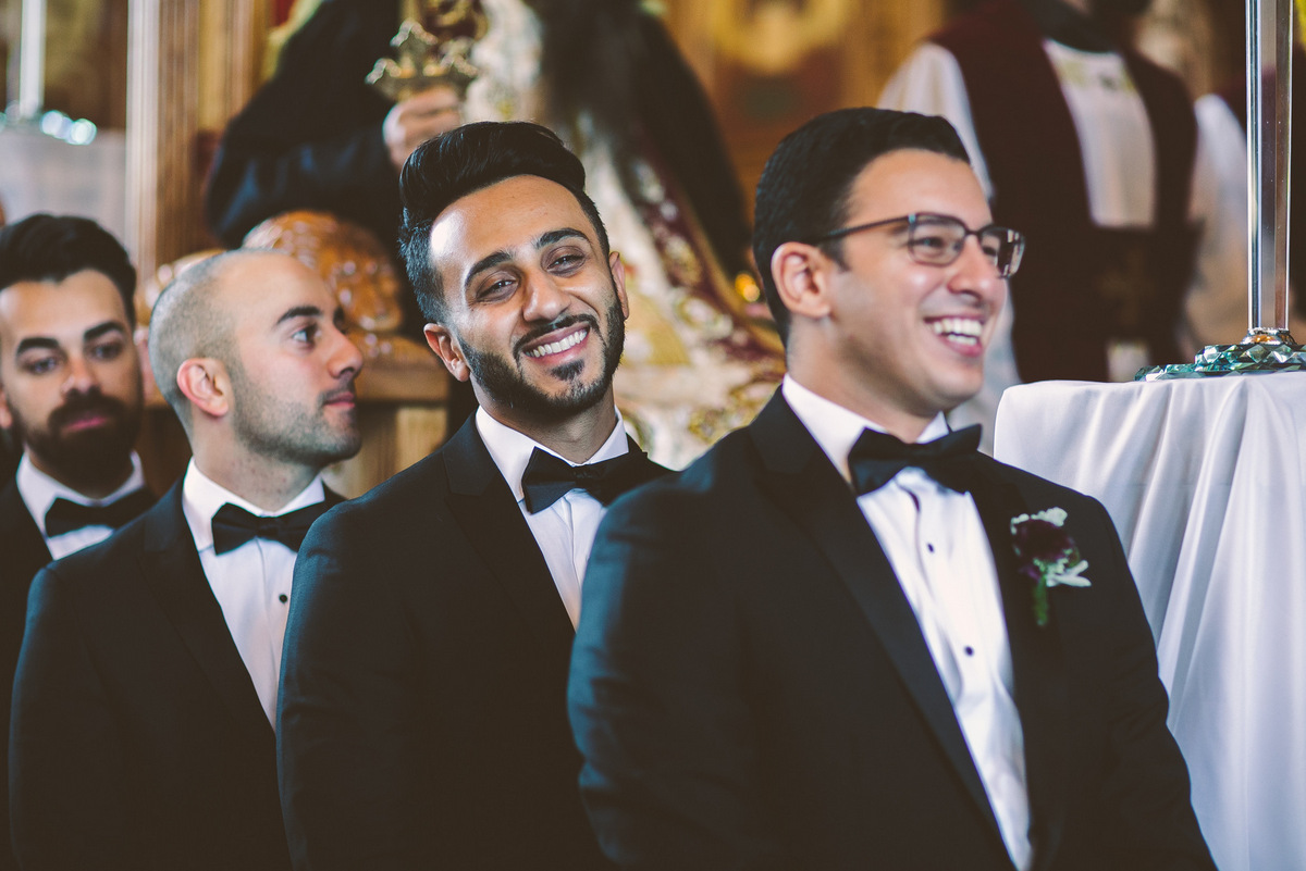 The groomsmen enjoy a laugh during the wedding ceremony