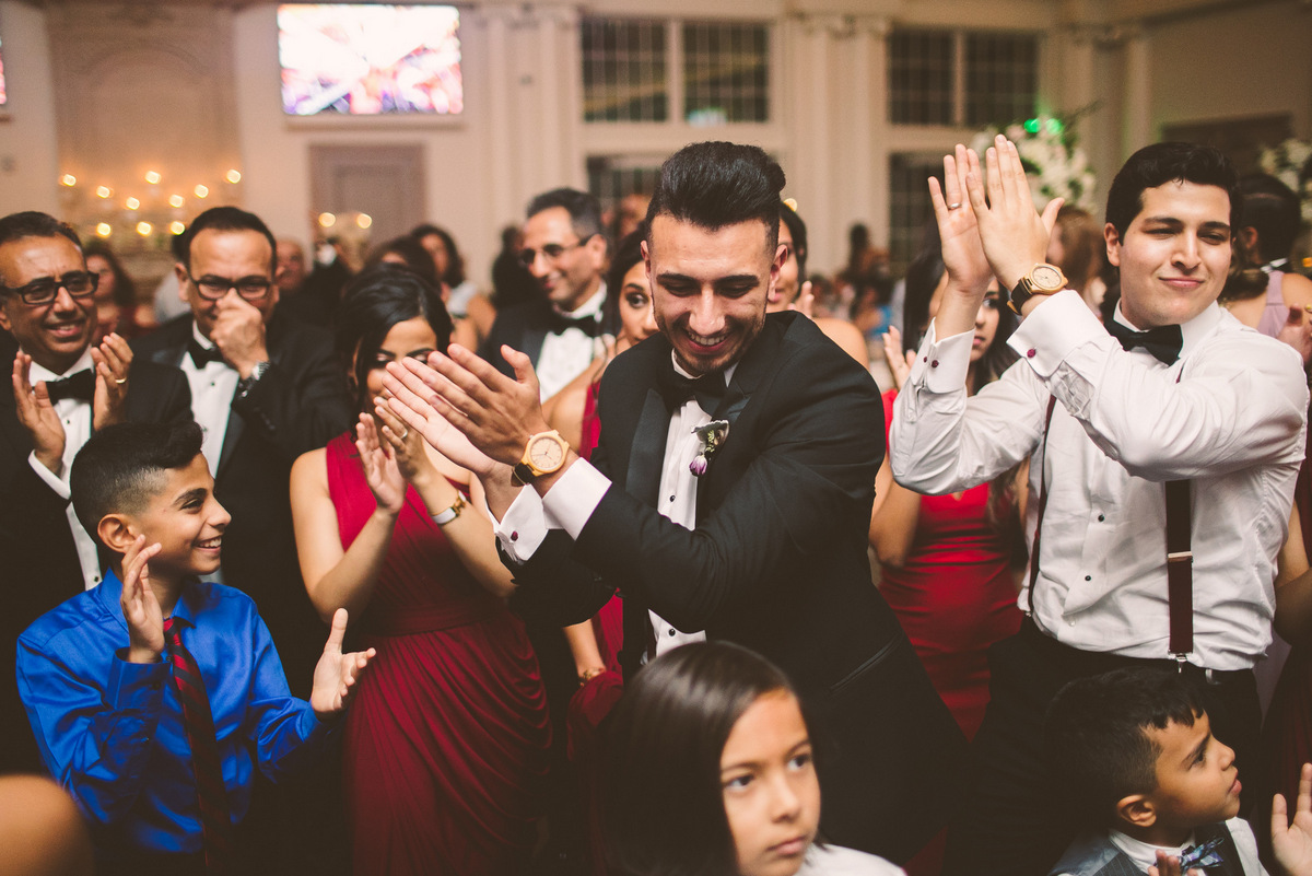 The bridal party claps and dances