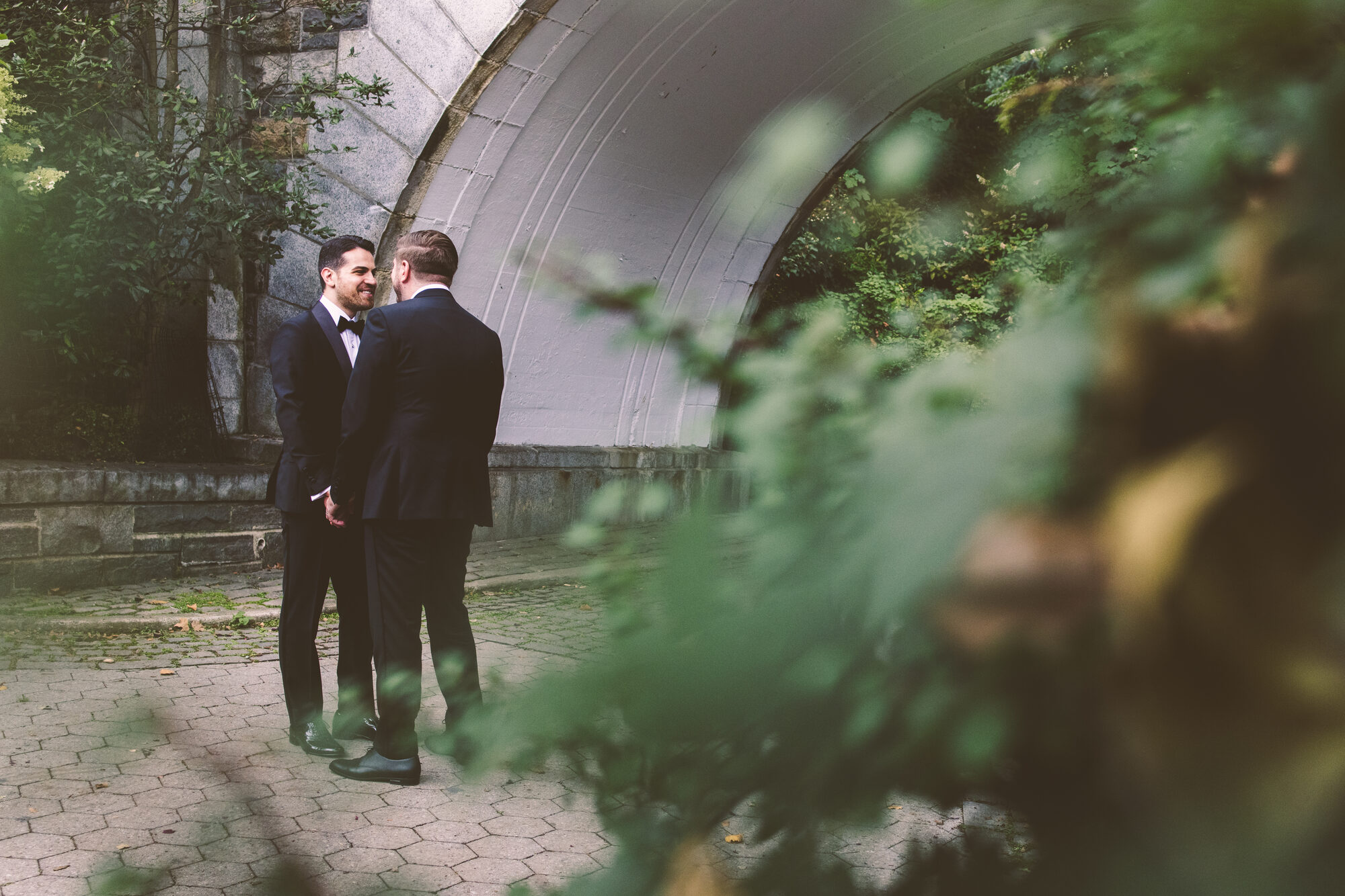 A kiss during wedding portraits in a New York City park