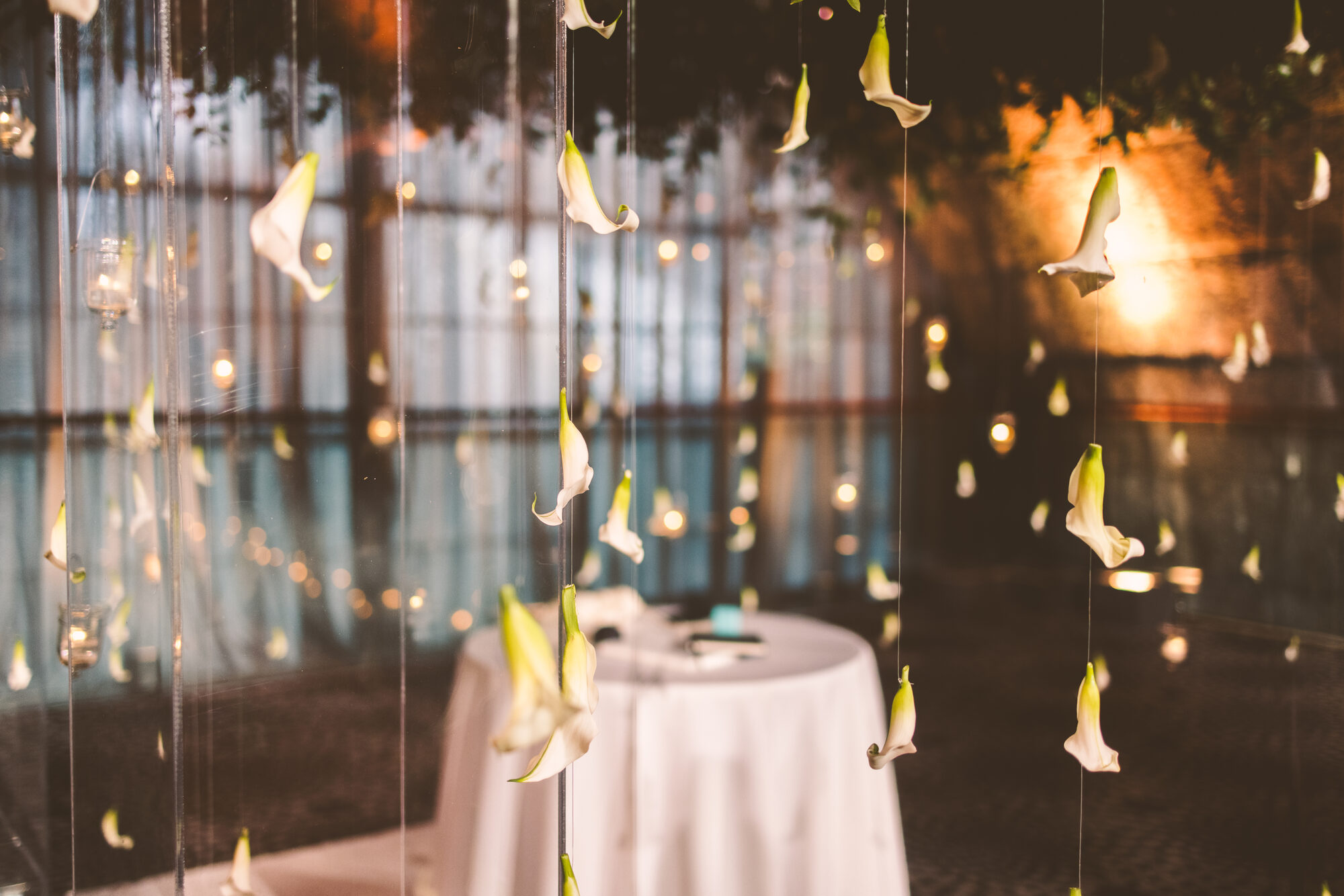 Candlelight and hanging florals in the ceremony space at Guastavino's
