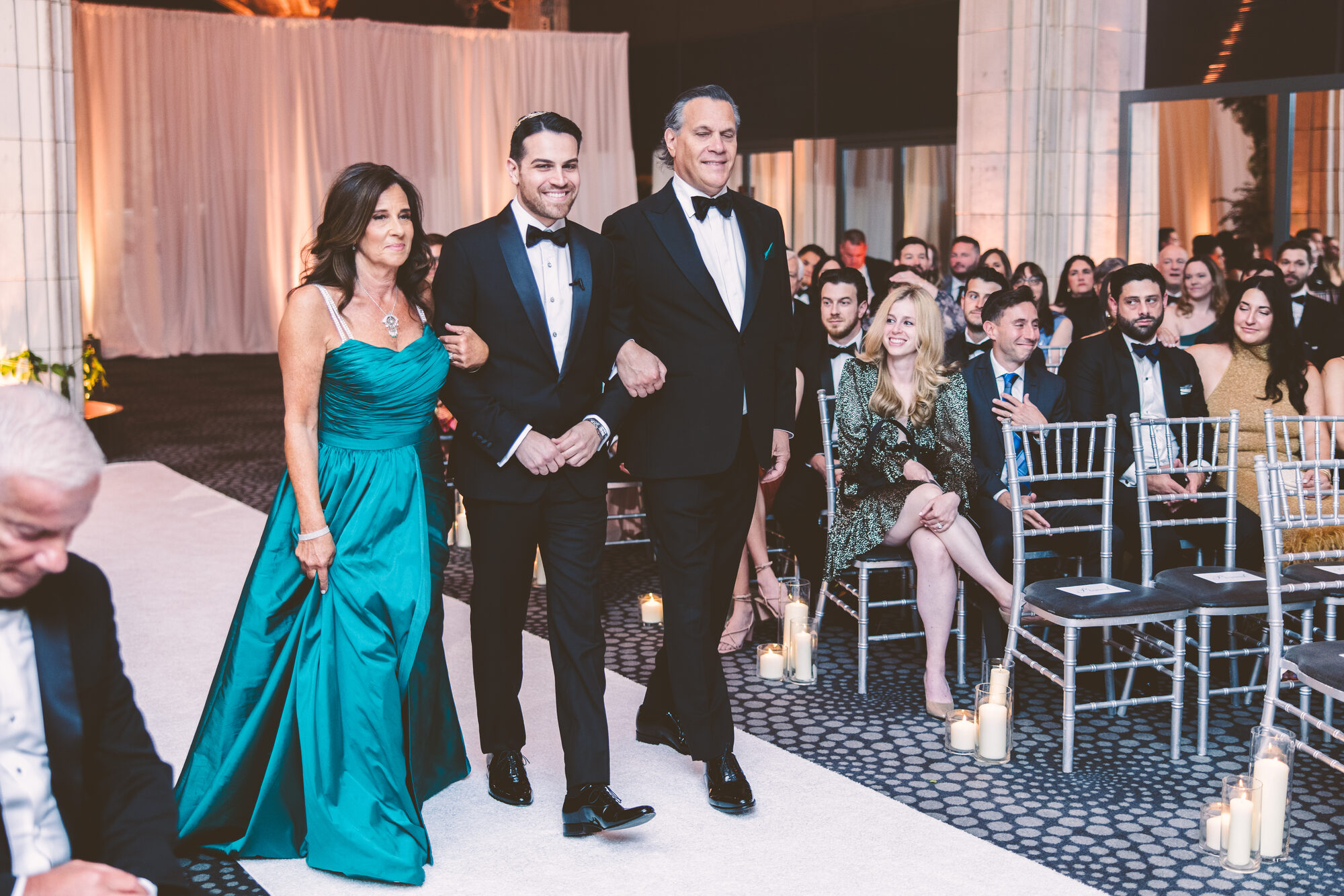 Parents escorting their son down the aisle at a Guastavino's wedding