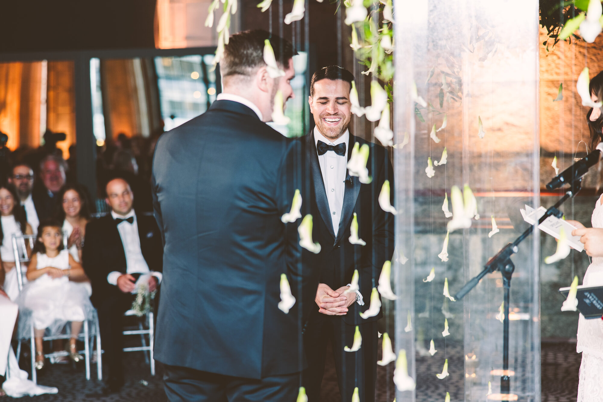 Two grooms standing together under the chuppah at Guastavino's