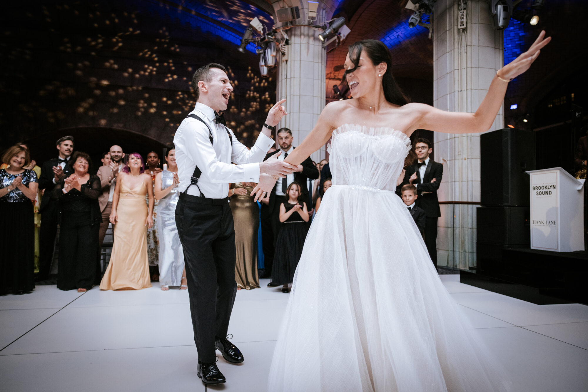 Bride and groom lifted on chairs