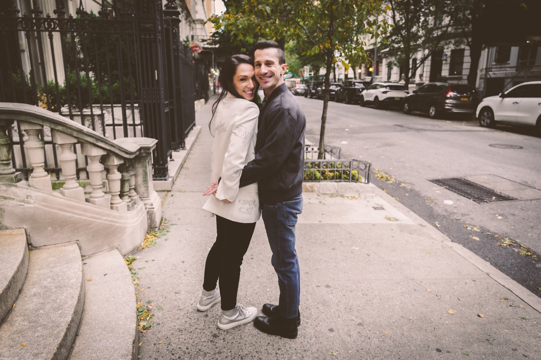 Couple walking together on an Upper East Side sidewalk.