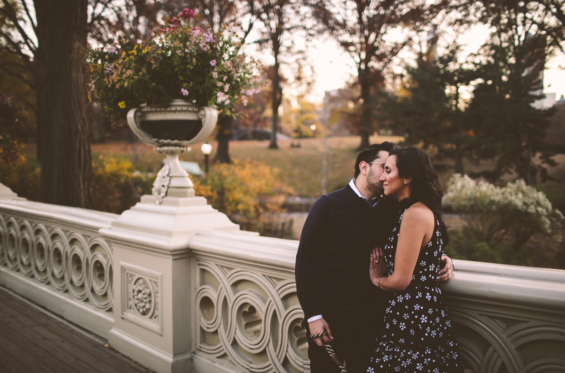 Couple embracing on Bow Bridge during a Central Park engagement session