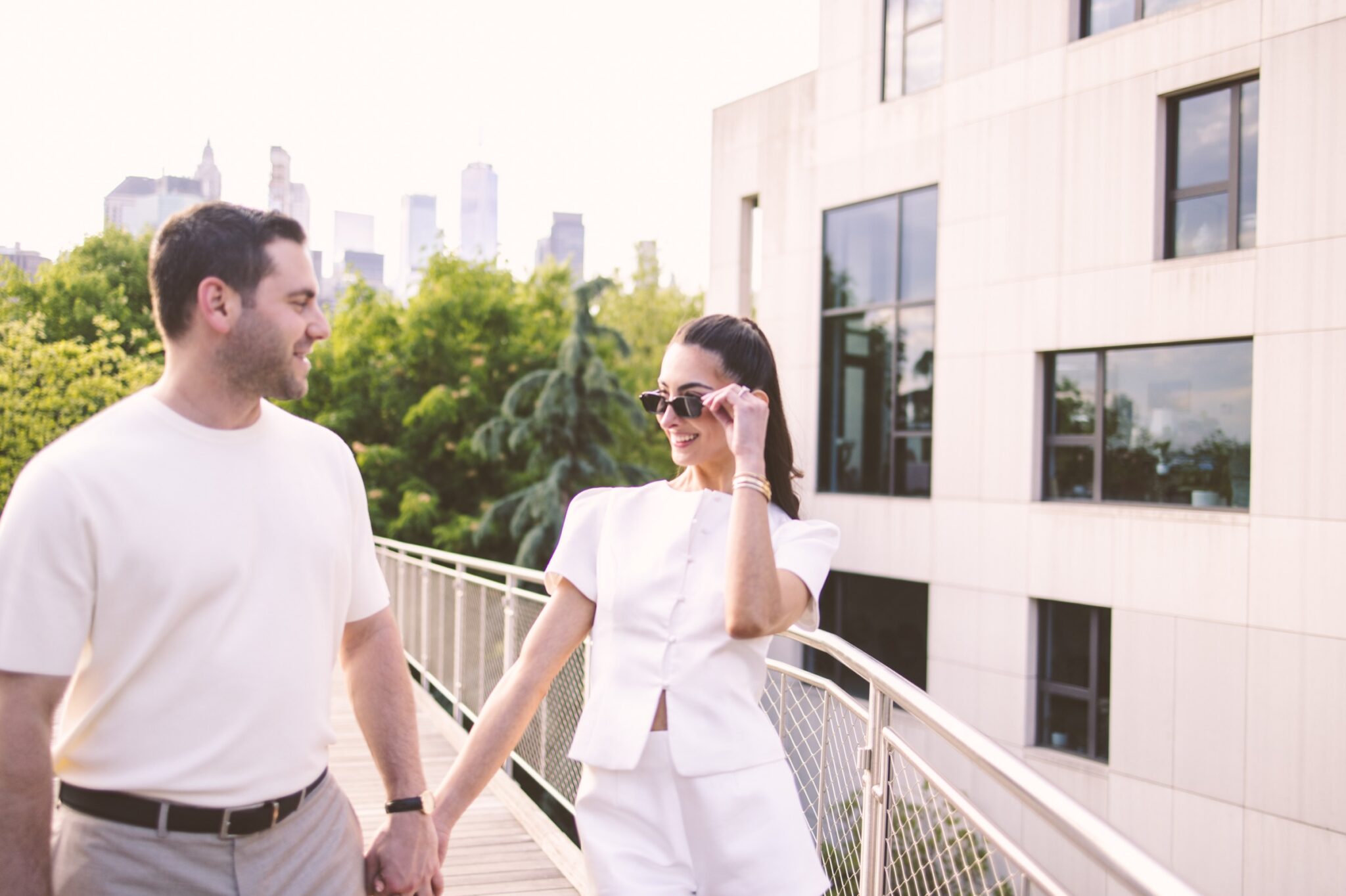 Couple walking together on an elevated path near the DUMBO waterfront