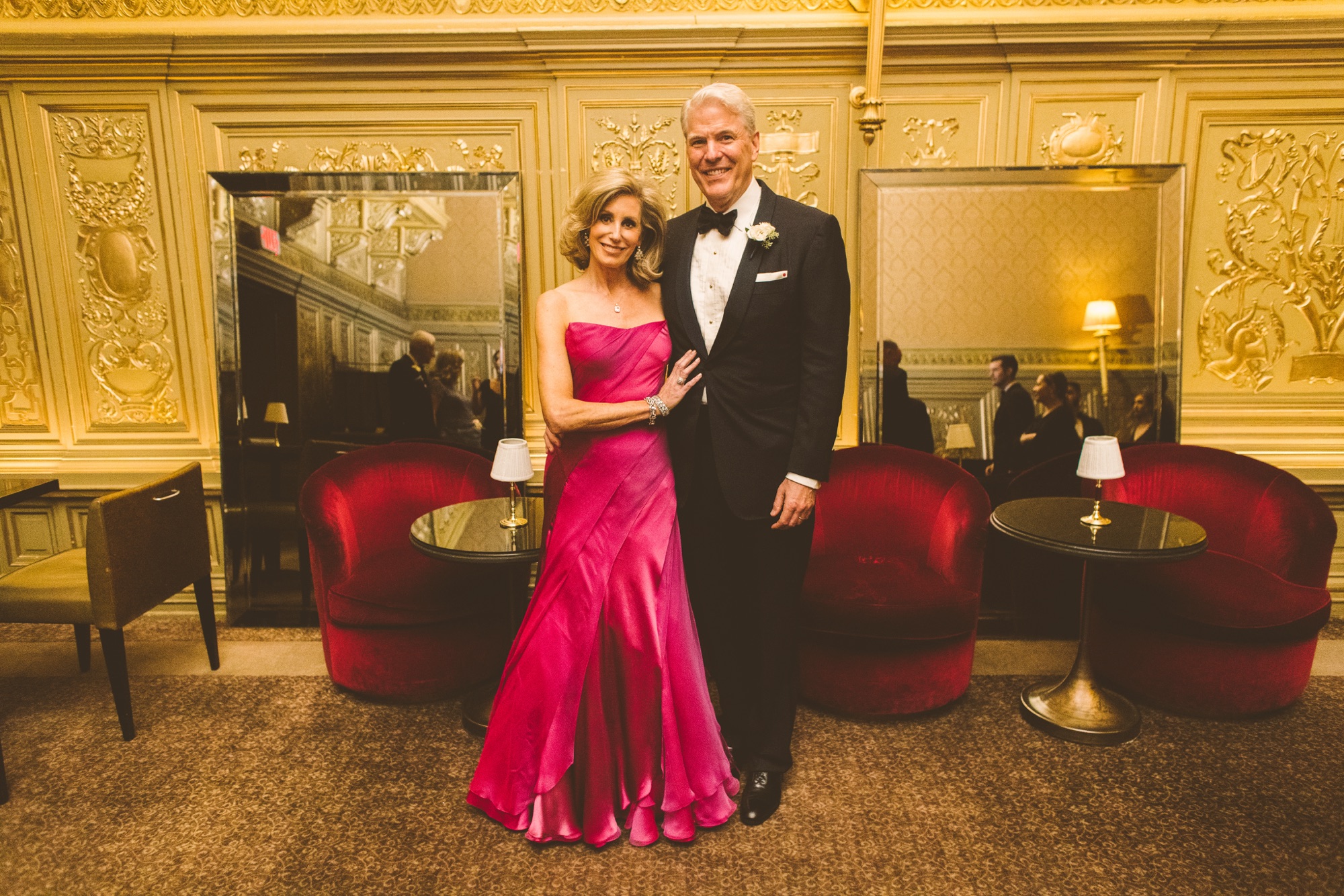 Guests in the gold room of the Villard Mansion, with its red velvet chairs and gilt panelling