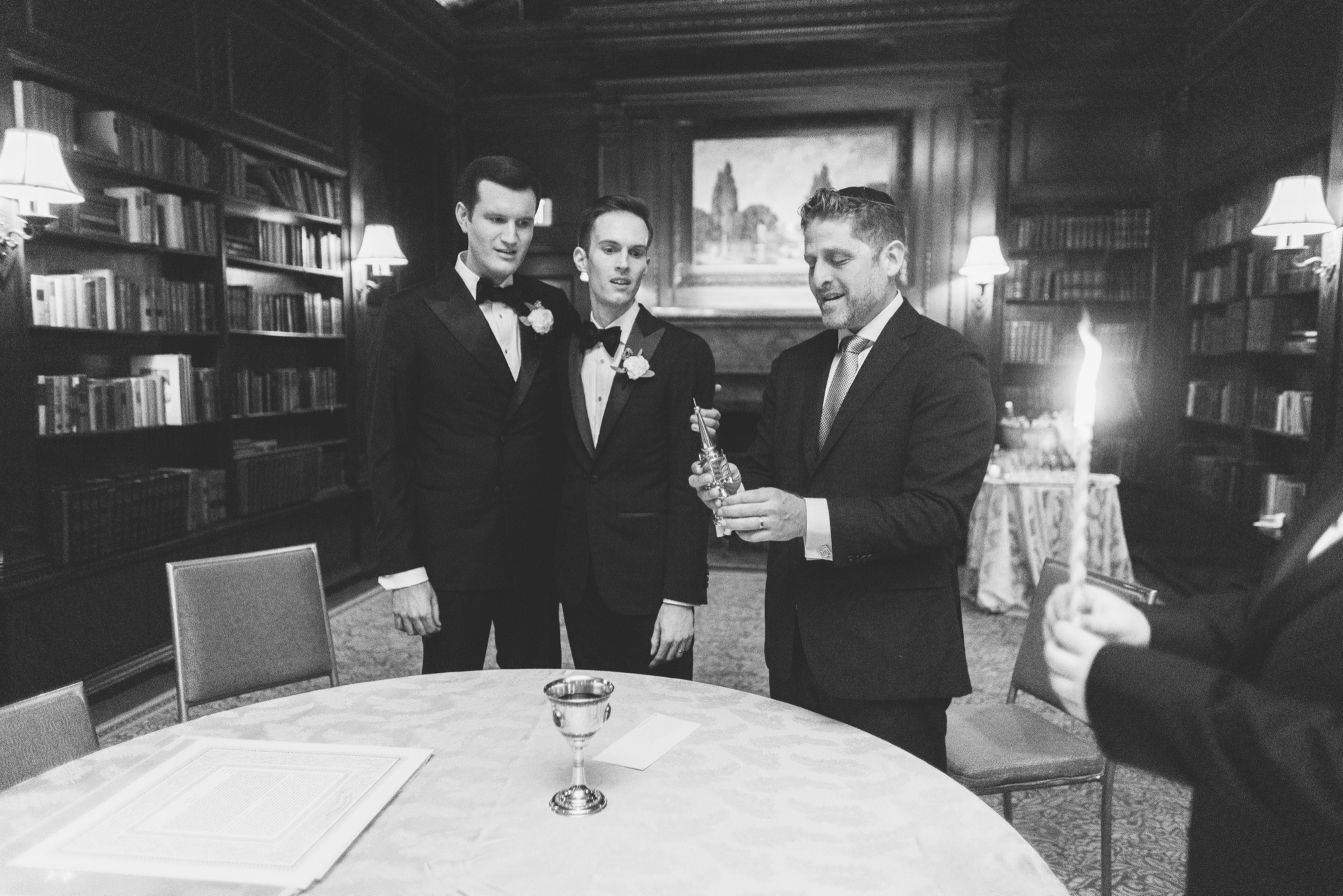 Black and white portrait of a couple raising champagne in the library